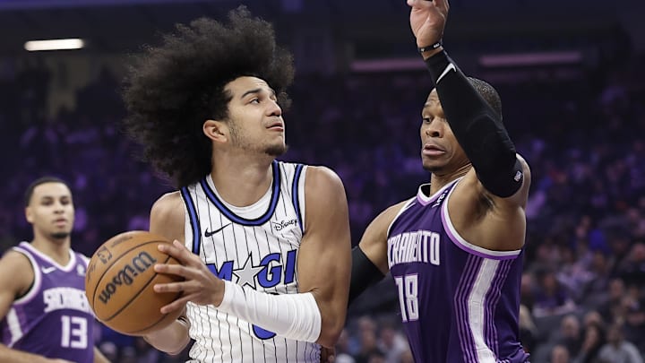 Feb 19, 2026; Sacramento, California, USA; Orlando Magic guard Anthony Black (0) drives in against Sacramento Kings guard Russell Westbrook (18) during the first quarter at Golden 1 Center.