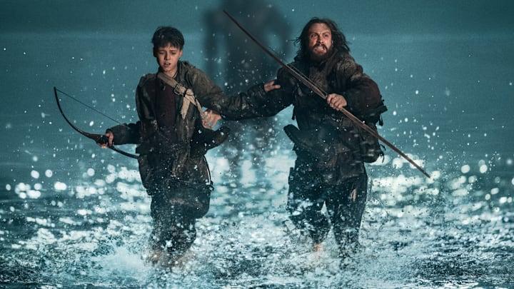 Jamie (Aaron Taylor-Johnson) and his son Spike (Alfie Williams) being chased by a Berserker in Columbia Pictures' 28 YEARS LATER. 