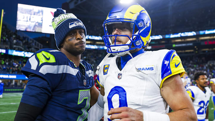 Nov 3, 2024; Seattle, Washington, USA; Seattle Seahawks quarterback Geno Smith (7) and Los Angeles Rams quarterback Matthew Stafford (9) greet each other following an overtime victory by the Rams at Lumen Field. Mandatory Credit: Joe Nicholson-Imagn Images