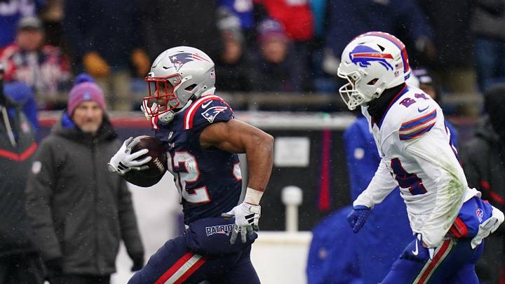 Dec 14, 2025; Foxborough, Massachusetts, USA; New England Patriots running back Treveyon Henderson (32) runs the ball for a touchdown against Buffalo Bills safety Cole Bishop (24) in the first half at Gillette Stadium. Mandatory Credit: David Butler II-Imagn Images