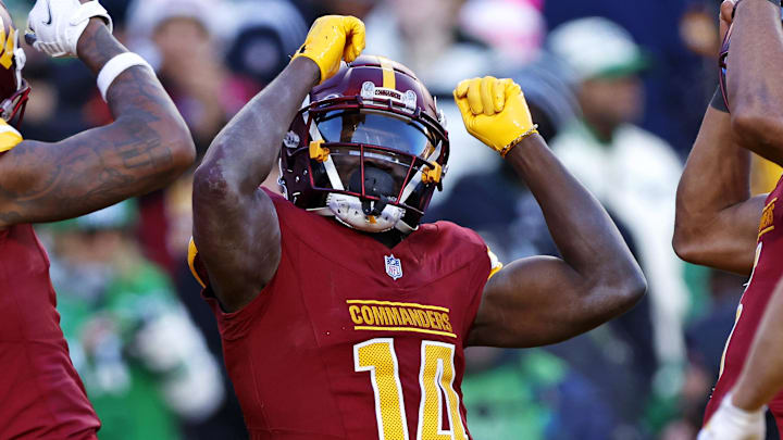 Dec 22, 2024; Landover, Maryland, USA; Washington Commanders wide receiver Olamide Zaccheaus (14)  with teammates  after scoring a touchdown during the fourth quarter at Northwest Stadium. Mandatory Credit: Peter Casey-Imagn Images