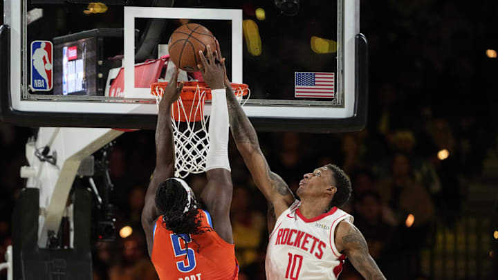 Dec 14, 2024; Las Vegas, Nevada, USA; Oklahoma City Thunder guard Luguentz Dort (5) shoots against Houston Rockets forward Jabari Smith Jr. (10) during the fourth quarter in a semifinal of the 2024 Emirates NBA Cup at T-Mobile Arena. Mandatory Credit: Kyle Terada-Imagn Images