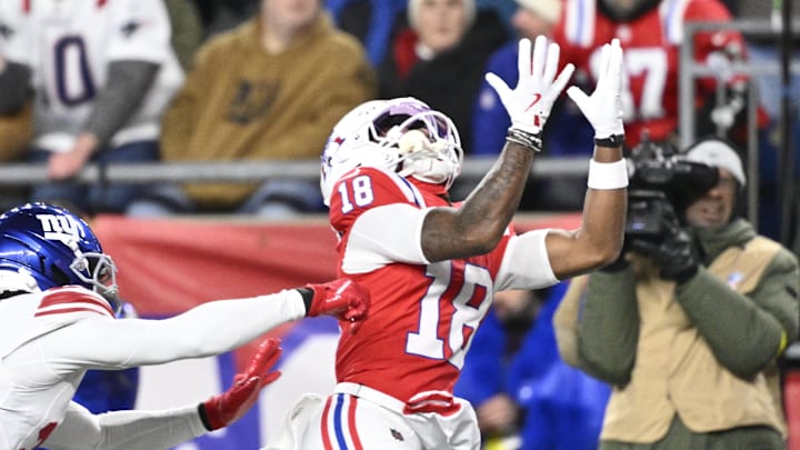 Dec 1, 2025; Foxborough, Massachusetts, USA; New England Patriots wide receiver Kyle Williams (18) catches a pass for a touchdown against New York Giants cornerback Paulson Adebo (21) during the second quarter at Gillette Stadium. Mandatory Credit: Eric Canha-Imagn Images