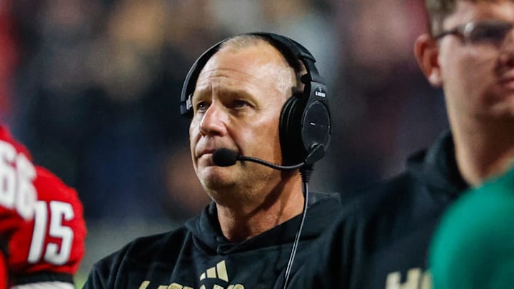 Nov 21, 2025; Raleigh, North Carolina, USA;  NC State Wolfpack head coach Dave Doeren looks on during the second half of the game against Florida State Seminoles at Carter-Finley Stadium. Mandatory Credit: Jaylynn Nash-Imagn Images