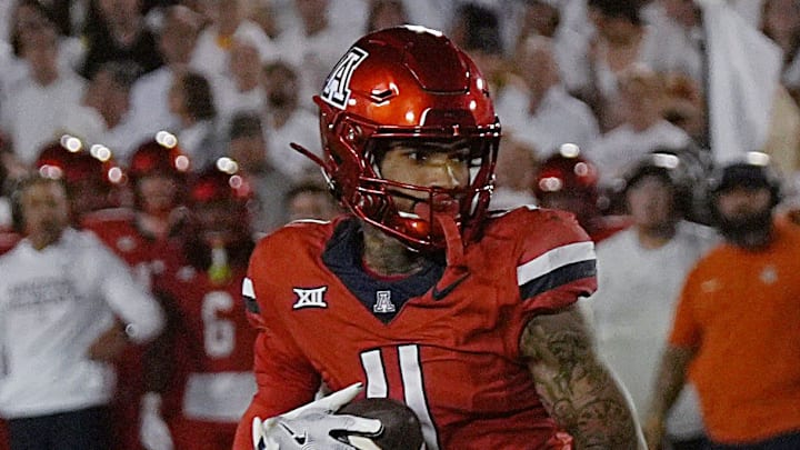 Arizona Wildcats wide receiver Kris Hutson (4) makes a catch around Iowa State Cyclones' linebacker Cael Brezina (9) during the third quarter in the Big-12 conference showdown on Sept. 27, 2025, at Jack Trice Stadium in Ames, Iowa.