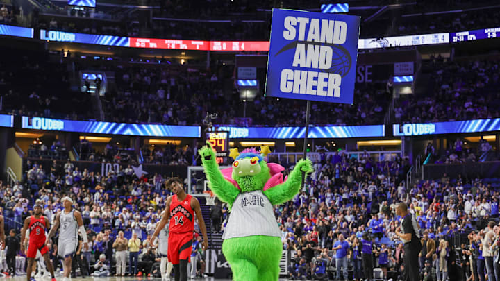 Mar 2, 2025; Orlando, Florida, USA; Orlando Magic mascot Stuff gets the fans to stand and cheer during the second half against the Toronto Raptors at Kia Center. Mandatory Credit: Mike Watters-Imagn Images Mar 2, 2025; Orlando, Florida, USA; Orlando Magic mascot Stuff gets the fans to stand and cheer during the second half against the Toronto Raptors at Kia Center. Mandatory Credit: Mike Watters-Imagn Images