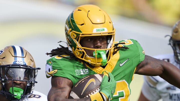 Aug 30, 2025; Eugene, Oregon, USA; Oregon Ducks running back Dierre Hill Jr. (23) runs with the ball during the second half against Montana State Bobcats defensive back Carson Williams (8) at Autzen Stadium. Mandatory Credit: Troy Wayrynen-Imagn Images Aug 30, 2025; Eugene, Oregon, USA; Oregon Ducks running back Dierre Hill Jr. (23) runs with the ball during the second half against Montana State Bobcats defensive back Carson Williams (8) at Autzen Stadium. Mandatory Credit: Troy Wayrynen-Imagn Images