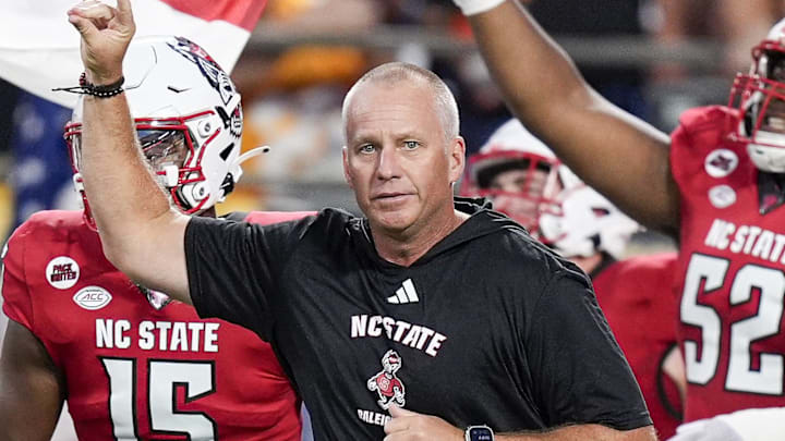 Sep 7, 2024; Charlotte, North Carolina, USA; North Carolina State Wolfpack head coach Dave Doeren leads his team onto the field against the Tennessee Volunteers during the first quarter at the Dukes Mayo Classic at Bank of America Stadium. Mandatory Credit: Jim Dedmon-Imagn Images Sep 7, 2024; Charlotte, North Carolina, USA; North Carolina State Wolfpack head coach Dave Doeren leads his team onto the field against the Tennessee Volunteers during the first quarter at the Dukes Mayo Classic at Bank of America Stadium. Mandatory Credit: Jim Dedmon-Imagn Images