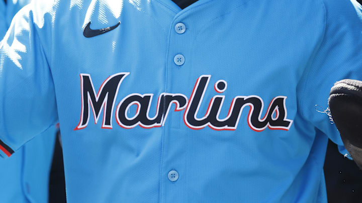 Mar 18, 2025; Jupiter, Florida, USA;  Miami Marlins shortstop Xavier Edwards (9) is congratulated in the dugout by teammates after scoring against the St. Louis Cardinals during the first inning at Roger Dean Chevrolet Stadium. Mandatory Credit: Rhona Wise-Imagn Images