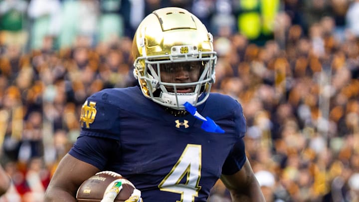 Nov 22, 2025; South Bend, Indiana, USA; Notre Dame Fighting Irish running back Jeremiyah Love (4) breaks loose for a touchdown run against the Syracuse Orange during the first half at Notre Dame Stadium. Mandatory Credit: Michael Caterina-Imagn Images
