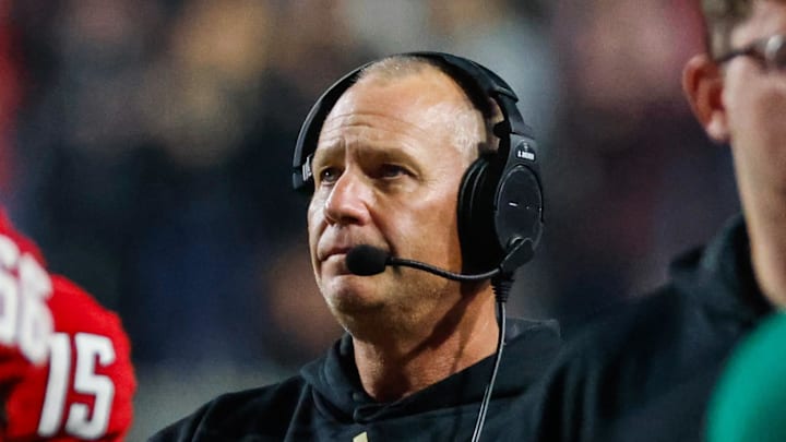 Nov 21, 2025; Raleigh, North Carolina, USA;  NC State Wolfpack head coach Dave Doeren looks on during the second half of the game against Florida State Seminoles at Carter-Finley Stadium. Mandatory Credit: Jaylynn Nash-Imagn Images