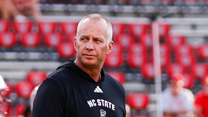 Aug 28, 2025; Raleigh, North Carolina, USA; North Carolina State Wolfpack head coach Dave Doeren walks among his players during the warmups prior to the game against East Carolina Pirates at Carter-Finley Stadium. Mandatory Credit: Jaylynn Nash-Imagn Images