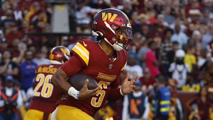 Washington Commanders quarterback Jayden Daniels (5) runs with the ball against the Carolina Panthers.