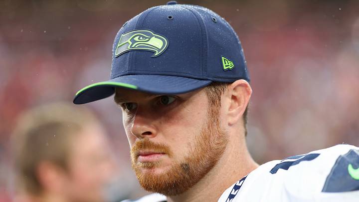 Seattle Seahawks quarterback Sam Darnold stands on the field