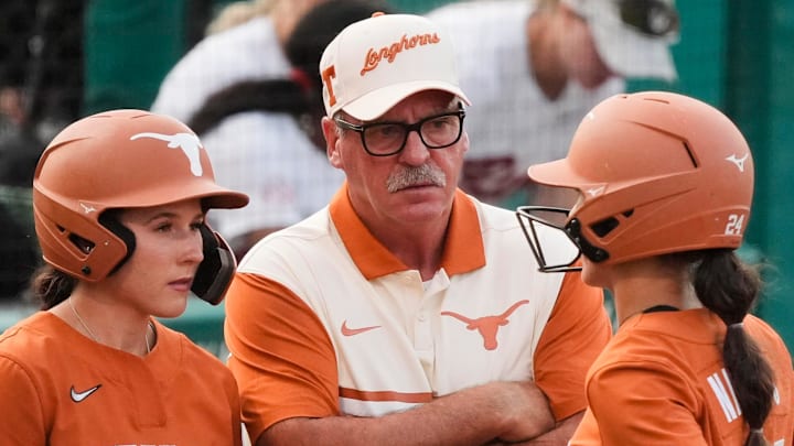 Texas Longhorns head coach Mike White talks to players Leighann Goode and Jaycie Nichols during a time out at Rhoads Stadium.