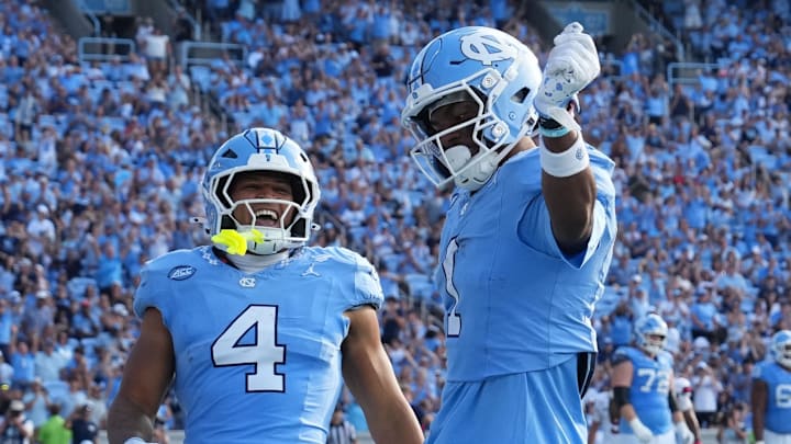 Sep 13, 2025; Chapel Hill, North Carolina, USA; North Carolina Tar Heels wide receiver Jordan Shipp (1) celebrates with wide receiver Alex Taylor (0) and running back Caleb Hood (4) after making a touchdown catch in the third quarter at Kenan Stadium. Sep 13, 2025; Chapel Hill, North Carolina, USA; North Carolina Tar Heels wide receiver Jordan Shipp (1) celebrates with wide receiver Alex Taylor (0) and running back Caleb Hood (4) after making a touchdown catch in the third quarter at Kenan Stadium.