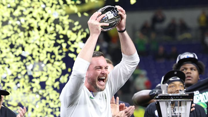 Dec 7, 2024; Indianapolis, IN, USA; Oregon Ducks head coach Dan Lanning and the Oregon Ducks celebrate defeating the Penn State Nittany Lions to win the Big Ten Championship in the 2024 Big Ten Championship game at Lucas Oil Stadium. Mandatory Credit: Jordan Prather-Imagn Images