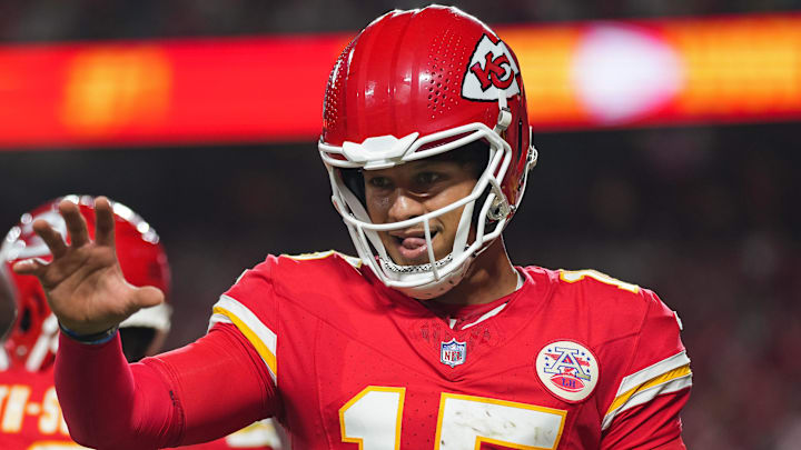 Sep 5, 2024; Kansas City, Missouri, USA; Kansas City Chiefs starting quarterback Patrick Mahomes (15) retrieves a touchdown ball belonging to wide receiver Xavier Worthy (not pictured) during the second half against the Baltimore Ravens at GEHA Field at Arrowhead Stadium. Mandatory Credit: Jay Biggerstaff-Imagn Images
