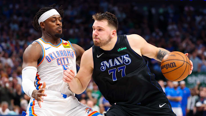 May 18, 2024; Dallas, Texas, USA;  Dallas Mavericks guard Luka Doncic (77) controls the ball as Oklahoma City Thunder guard Luguentz Dort (5) defends during the second half in game six of the second round of the 2024 NBA playoffs at American Airlines Center. Mandatory Credit: Kevin Jairaj-Imagn Images