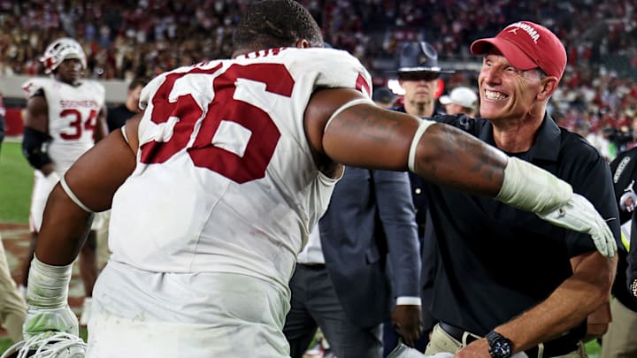 Oklahoma coach Brent Venables embraces senior Gracen Halton after the Sooners knocked off Alabama.