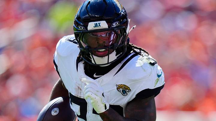 Sep 20, 2026; Denver, Colorado, USA;  Jacksonville Jaguars running back Bhayshul Tuten (33) rushes the ball against the Denver Broncos in the first half at Empower Field at Mile High.  