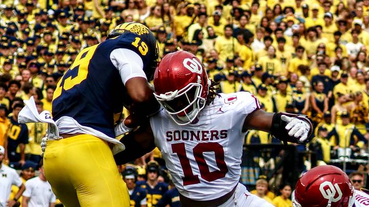 Oklahoma linebacker Kip Lewis tries to tackle Michigan quarterback Bryce Underwood.