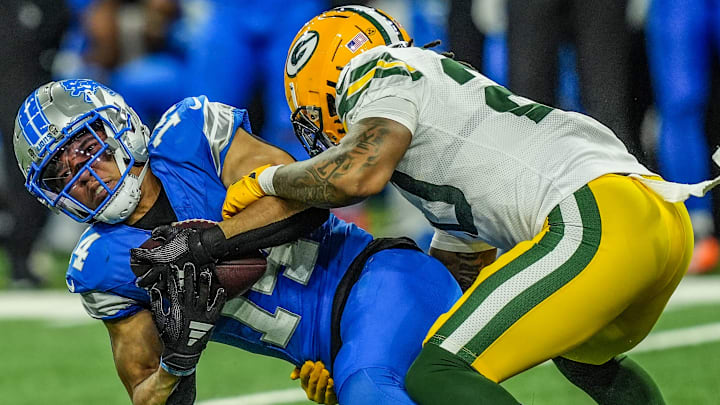 Detroit Lions wide receiver Amon-Ra St. Brown makes a catch while hit by Green Bay Packers safety Javon Bullard 