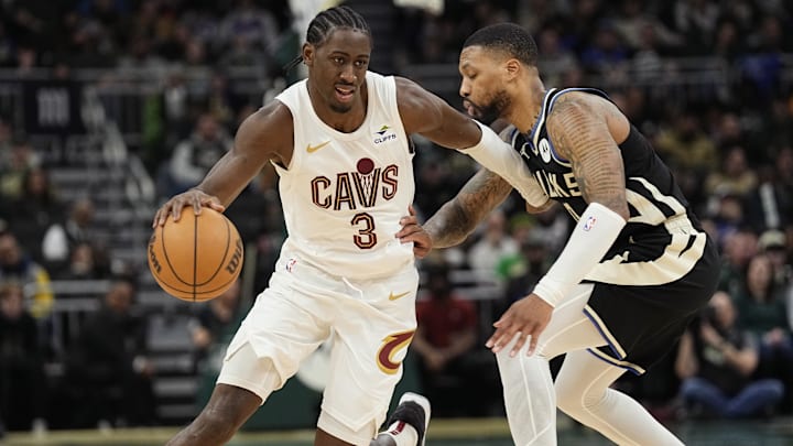 Jan 26, 2024; Milwaukee, Wisconsin, USA;  Cleveland Cavaliers forward Caris LeVert (3) drives towards the basket around Milwaukee Bucks guard Damian Lillard (0) during the fourth quarter at Fiserv Forum. Mandatory Credit: Jeff Hanisch-Imagn Images
