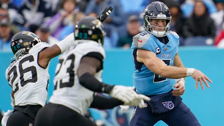 Tennessee Titans quarterback Will Levis (8) passes around Jacksonville Jaguars safety Antonio Johnson (26) during the third quarter at Nissan Stadium in Nashville, Tenn., Sunday, Dec. 8, 2024.