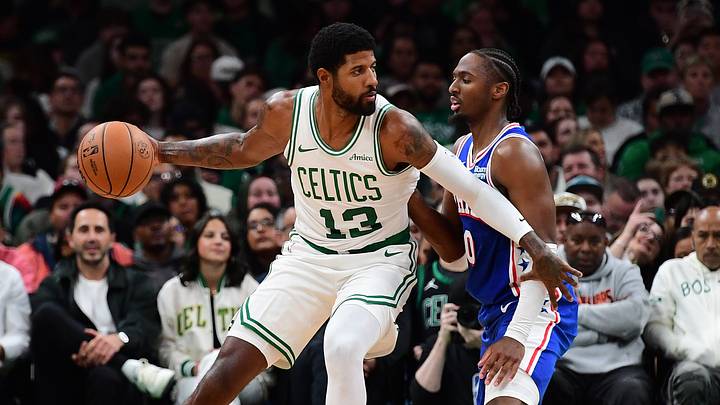 Oct 10, 2026; Boston, Massachusetts, USA;  Boston Celtics forward Paul George (13) controls the ball while Philadelphia 76ers guard Tyrese Maxey (0) defends during the first half at TD Garden. Mandatory Credit: Bob DeChiara-Imagn Images