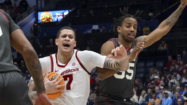 Arkansas Razorbacks forward Trevon Brazile (7) dribbles the ball past Oklahoma Sooners forward Derrion Reid (35) during the first half at Bridgestone Arena.