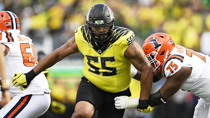 Oct 26, 2024; Eugene, Oregon, USA; Oregon Ducks defensive lineman Derrick Harmon (55) breaks past Illinois Fighting Illini offensive lineman Brandon Henderson (75) during the second half at Autzen Stadium. Mandatory Credit: Troy Wayrynen-Imagn Images