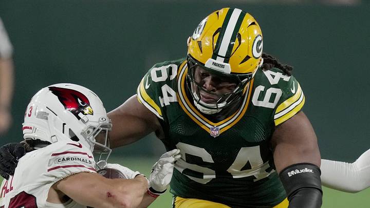 Green Bay Packers defensive tackle Jonathan Ford (64) tackles Arizona Cardinals running back Evan Hull. Green Bay Packers defensive tackle Jonathan Ford (64) tackles Arizona Cardinals running back Evan Hull.