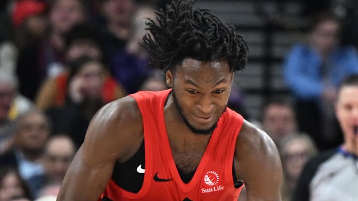 Toronto Raptors guard Immanuel Quickley steals the ball from Los Angeles Lakers forward LeBron James