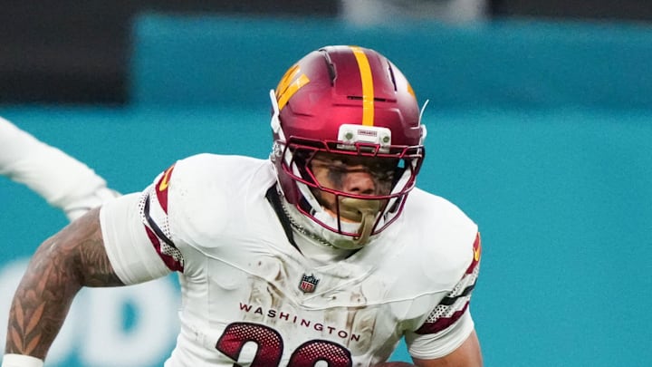 Washington Commanders running back Chris Rodriguez Jr. carries the ball against the Miami Dolphins.