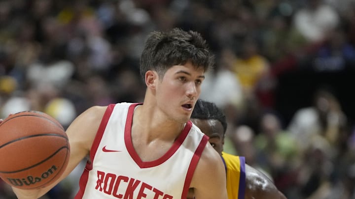 Jul 12, 2024; Las Vegas, NV, USA;  Houston Rockets guard Reed Sheppard (15) dribbles the ball against Los Angeles Lakers guard Bronny James (9) during the first half at the Thomas & Mack Center. Mandatory Credit: Lucas Peltier-Imagn Images
