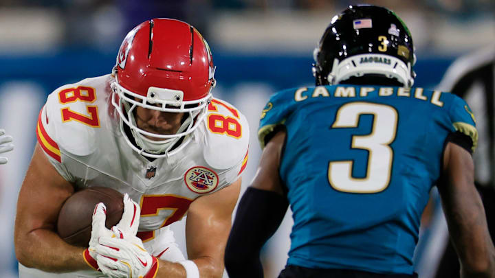 Kansas City Chiefs tight end Travis Kelce (87) rushes for yards against Jacksonville Jaguars linebacker Dennis Gardeck (47) and cornerback Tyson Campbell (3) during the first quarter of an NFL football matchup at EverBank Stadium, Monday, Oct. 6, 2025, in Jacksonville, Fla. The Jacksonville Jaguars edged the Kansas City Chiefs 31-28. [Corey Perrine/Florida Times-Union]