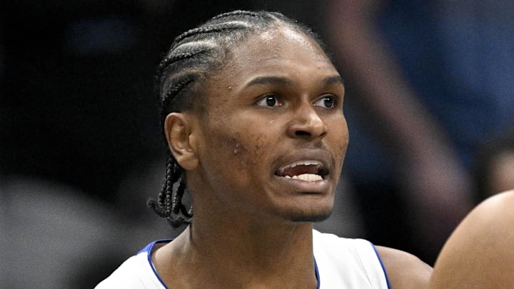 Detroit Pistons guard Ausar Thompson (9) is restrained by forward Tobias Harris (12) as Thompson reacts to being thrown out of the game against the Dallas Mavericks by NBA referee John Goble (not pictured) during the second quarter at the American Airlines Center on Dec 18 2025.