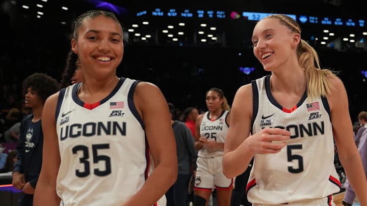 Dec 7, 2024; Brooklyn, New York, USA; Connecticut Huskies guard Azzi Fudd (35) and Connecticut Huskies guard Paige Bueckers (5) celebrate after the game against the Louisville Cardinals at Barclays Center. Mandatory Credit: Lucas Boland-Imagn Images