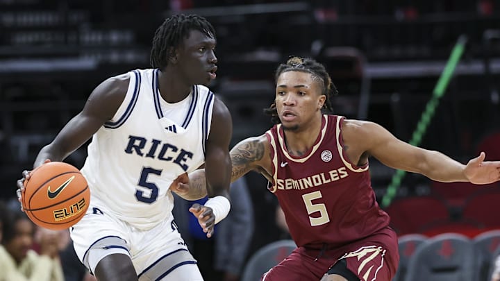 Nov 9, 2024; Houston, Texas, USA; Rice Owls guard Jacob Dar (5) controls the ball as Florida State Seminoles guard Daquan Davis (5) defends during the first half at Toyota Center. Mandatory Credit: Troy Taormina-Imagn Images