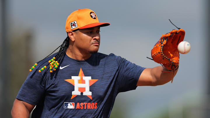 Feb 14, 2025; West Palm Beach, FL, USA; Houston Astros starting pitcher Luis Garcia (77) works on a fielding exercise during a spring training workout at CACTI Park of the Palm Beaches. 
