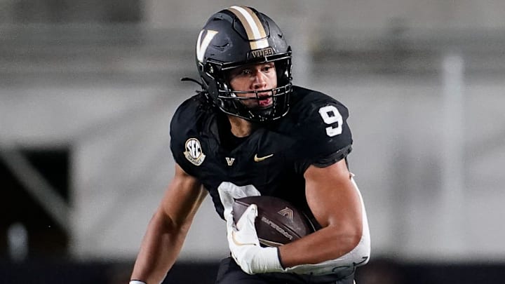 Vanderbilt tight end Eli Stowers (9) evades Ball State defensive back George Udo (10) during the fourth quarter at FirstBank Stadium in Nashville, Tenn., Saturday, Oct. 19, 2024.