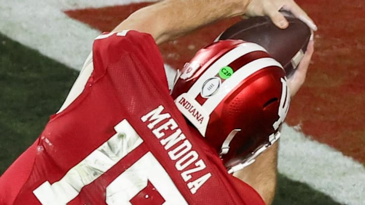 Jan 19, 2026; Miami Gardens, FL, USA; Indiana Hoosiers quarterback Fernando Mendoza (15) carries the ball for a touchdown against the Miami Hurricanes in the fourth quarter during the College Football Playoff National Championship game at Hard Rock Stadium. Mandatory Credit: Kim Klement Neitzel-Imagn Images