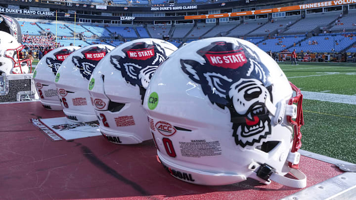 Sep 7, 2024; Charlotte, North Carolina, USA; North Carolina State Wolfpack helmets during pregame activity for the Dukes Mayo Classic against the Tennessee Volunteers at Bank of America Stadium. Mandatory Credit: Jim Dedmon-Imagn Images Sep 7, 2024; Charlotte, North Carolina, USA; North Carolina State Wolfpack helmets during pregame activity for the Dukes Mayo Classic against the Tennessee Volunteers at Bank of America Stadium. Mandatory Credit: Jim Dedmon-Imagn Images