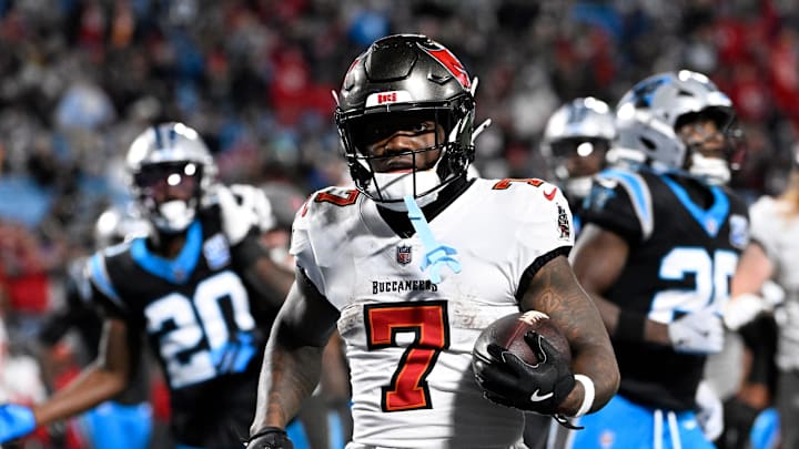 Dec 1, 2024; Charlotte, North Carolina, USA;  Tampa Bay Buccaneers running back Bucky Irving (7) scores a touchdown in the fourth quarter at Bank of America Stadium. Mandatory Credit: Bob Donnan-Imagn Images