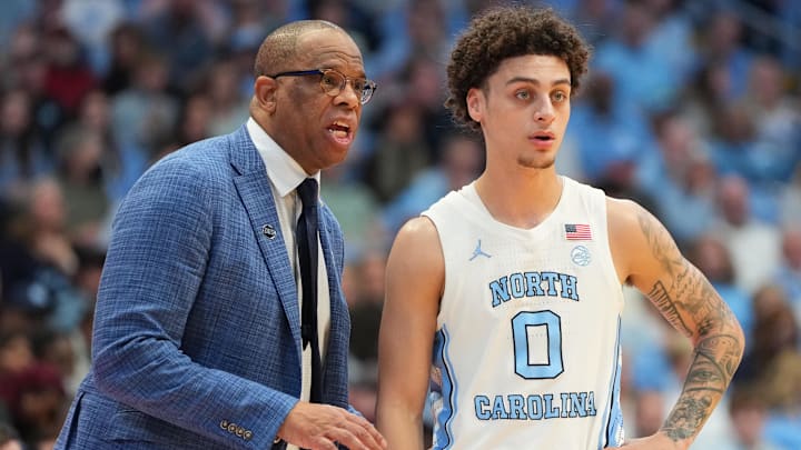 Feb 28, 2026; Chapel Hill, North Carolina, USA; North Carolina Tar Heels head coach Hubert Davis with guard Kyan Evans (0) in the second half at Dean E. Smith Center. Mandatory Credit: Bob Donnan-Imagn Images