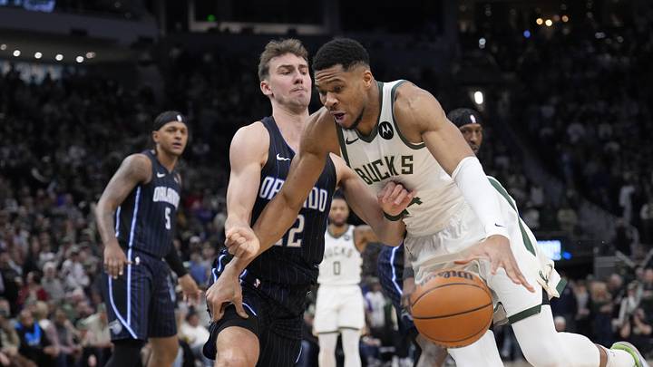 Mar 8, 2025; Milwaukee, Wisconsin, USA; Milwaukee Bucks forward Giannis Antetokounmpo (34) drives against Orlando Magic forward Franz Wagner (22) in the first half  at Fiserv Forum. Mandatory Credit: Michael McLoone-Imagn Images
