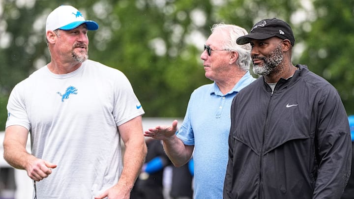 Detroit Lions head coach Dan Campbell, left, talks to team president and CEO Rod Wood and general manager Brad Holmes Detroit Lions head coach Dan Campbell, left, talks to team president and CEO Rod Wood and general manager Brad Holmes