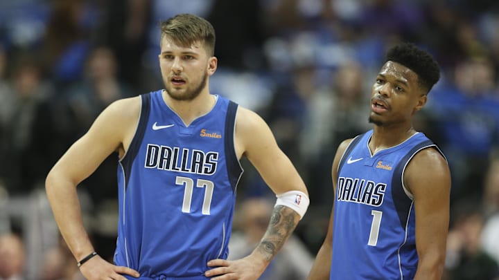 Jan 22, 2019; Dallas, TX, USA; Dallas Mavericks forward Luka Doncic (77) and  guard Dennis Smith Jr. (1) talk during the first quarter against the LA Clippers at American Airlines Center. Mandatory Credit: Kevin Jairaj-Imagn Images