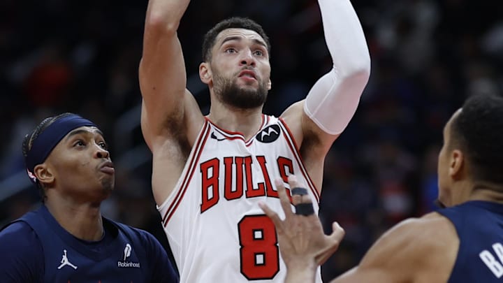 Nov 26, 2024; Washington, District of Columbia, USA; Chicago Bulls guard Zach LaVine (8) drives to the basket as Washington Wizards guard Bilal Coulibaly (0) and Wizards guard Malcolm Brogdon (15) defend in the third quarter at Capital One Arena. Mandatory Credit: Geoff Burke-Imagn Images